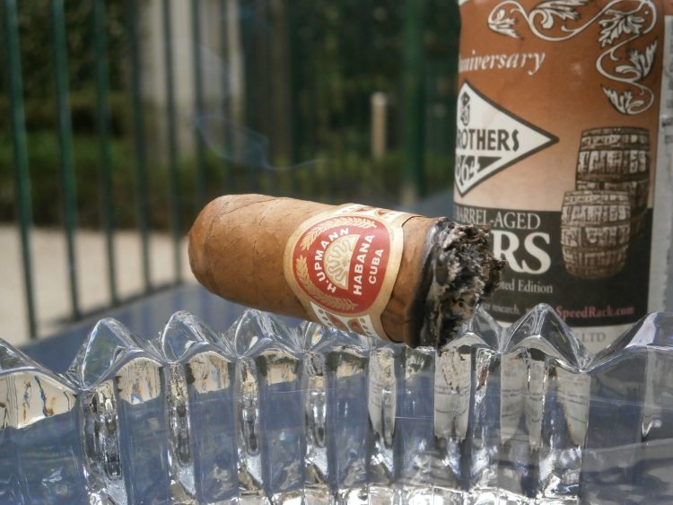H. Upmann Robustos 520 Aniversario, an inch left, with a Fee Brother's Bitters