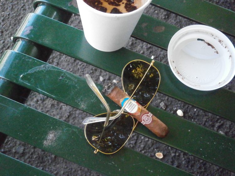 Montecristo B Compay Centennial Humidor, somewhat burnt, with Ray-Ban Aviators and a coffee