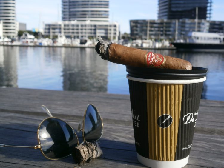 Partagás Sobresalientes Réplica de Humidor Antiguo, two thirds left, with a coffee and some Ray-Ban Aviators