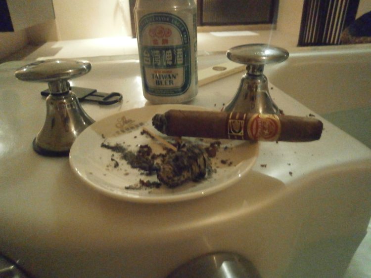 Partagás Salomones a quarter smoked, with a Taiwan Beer